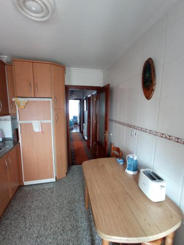a kitchen with a wooden table with a toaster on it at Puente Villanueva dreans in Medina de Pomar