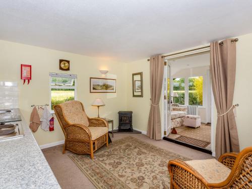 a living room with a chair and a fireplace at Sunbeck Gatehouse in Thormanby