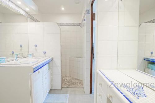 a bathroom with a sink and a tub at Villa Liléa in Saint-François