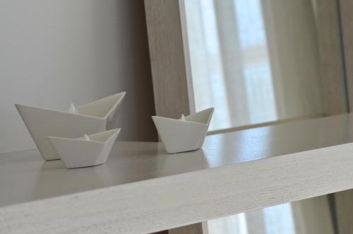 three white paper cups sitting on a table at Ino Hotel & Suites in Samos