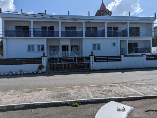 a white building on the side of a street at Inn The Town in Port Antonio
