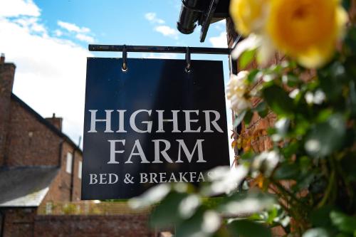 a sign that reads higher farm bed and breakfast at Higher Farm in Malpas