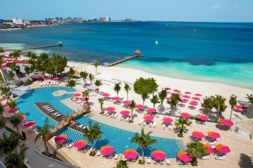 an aerial view of a beach with umbrellas and a pool at Breathless Cancun Soul Resort & Spa - Adults Only - All Inclusive in Cancún