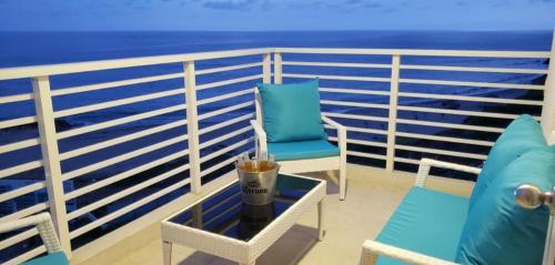een balkon met een stoel en een drankje op een tafel bij OCEAN CLUB 401 MEDITERRANEA in Playas