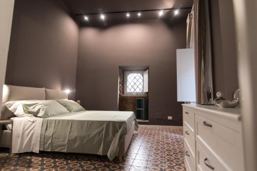 a bedroom with a bed with lights on the wall at il sacrato di casa loreto in Catania