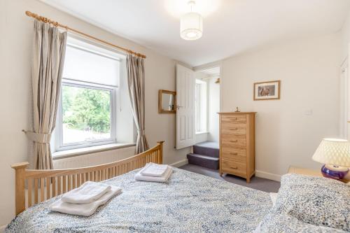 Postel nebo postele na pokoji v ubytování Swift Cottage