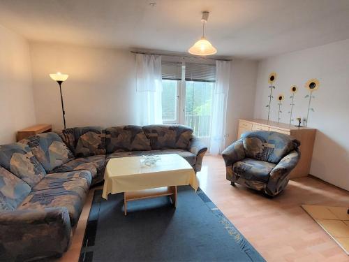 a living room with a couch and a table at Spacious holiday home in Neureichenau Schimmelbach in Neureichenau