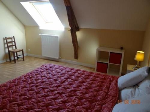 a bedroom with a large bed with a red blanket at Ferme rénovée avec verger, 7 km du Mans, cheminée, 4 chambres, draps inclus, calme assuré - FR-1-410-251 in La Bazoge