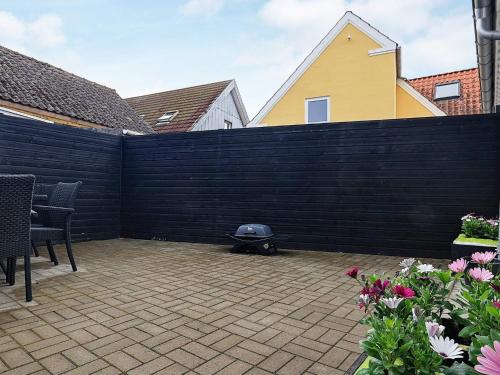 a backyard with a black fence and a grill at 6 person holiday home in Hals-By Traum in Hals