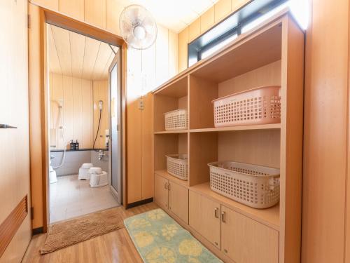 a bathroom with a closet with shelves and a toilet at Ryosou Minatosou Joetsu in Naoetsu