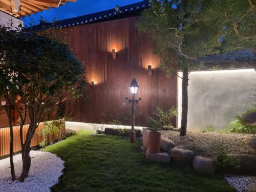 a garden at night with a street light and a fence at Yeonriji in Gyeongju