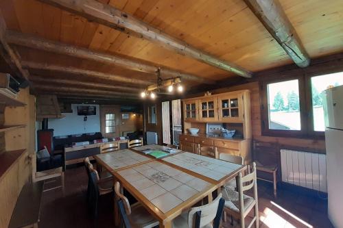 a dining room with a table and some chairs at Chalet at the foot of the Nordic domain in La Clusaz