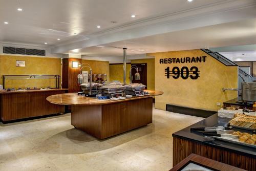 a restaurant with a counter with food on it at Great Southern Hotel Sydney in Sydney