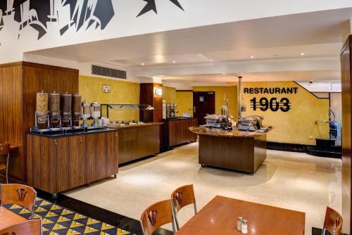 a restaurant with a bar and tables in a room at Great Southern Hotel Sydney in Sydney