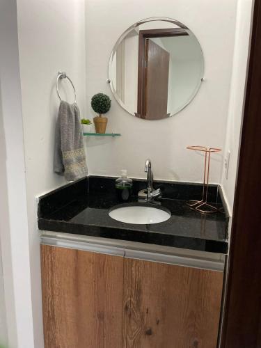 a bathroom with a sink and a mirror at Chalé Serra Nevada - Bananeiras in Bananeiras