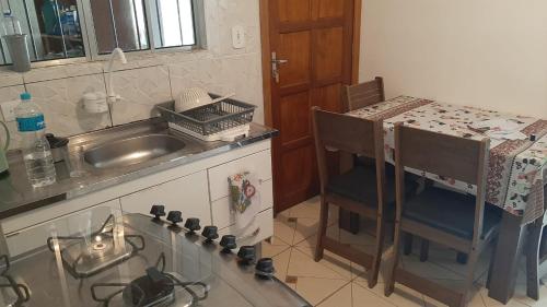 a kitchen with a sink and a counter top at Cantinho do Nono 3 in Campos do Jordão