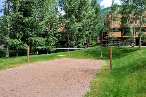 a volleyball court with a net in the grass at Revitalize in Vail in Vail