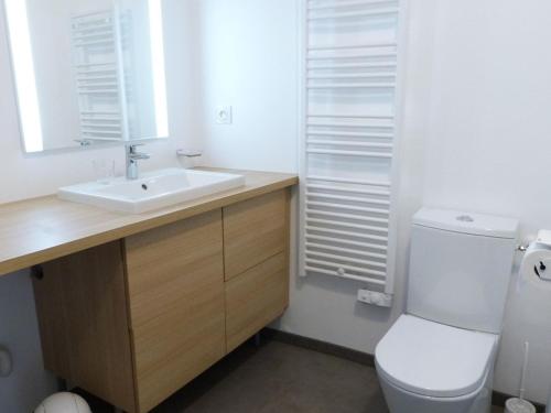 a bathroom with a white toilet and a sink at Appartement bord de mer avec accès plage, piscine, jacuzzi, 1 chambre, animaux admis, parking inclus - FR-1-194-253 in La Tranche-sur-Mer