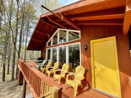 a porch of a house with chairs and windows at Contemporary Magic Mountain Chalet Close to Skiing, Hiking, Fun in Londonderry