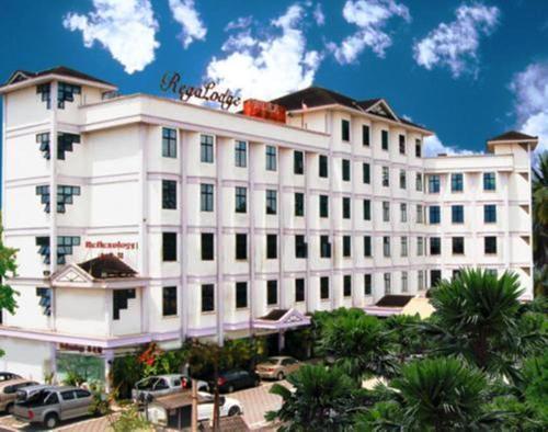 
a large building with a clock on the front of it at Regalodge Hotel Ipoh in Ipoh
