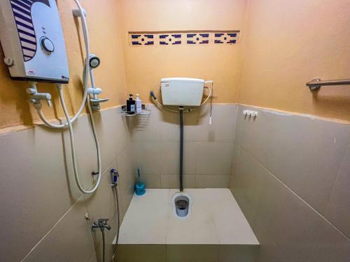 a bathroom with a shower with a toilet in it at Nail Guest House Kuala Besut in Kampong Nail