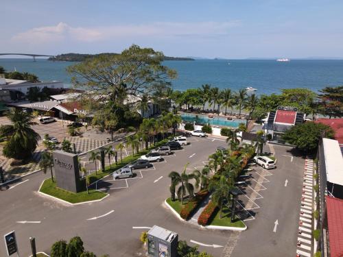 an aerial view of a parking lot next to the ocean at Queenco Hotel & Casino in Sihanoukville