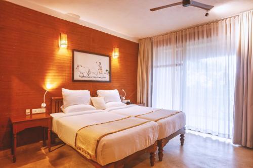 a bedroom with a large bed and a large window at AMARA AYURVEDA RETREAT- Overlooking Evergreen Western Ghats an ecologically sustainable living space in Kovalam in Kovalam