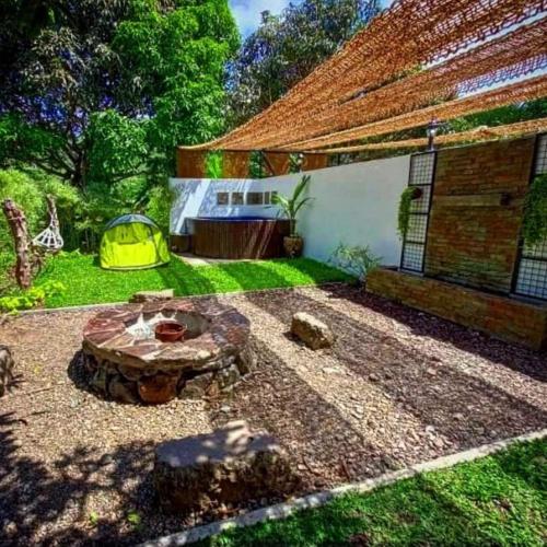a backyard with a fire pit and a tent at Casa de Cortijo in Pagbilao
