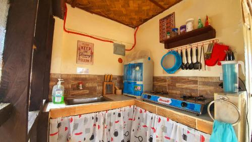 a kitchen with a sink and a counter top at Calatagan's Bahay Kubo - with Beach Access in Calatagan