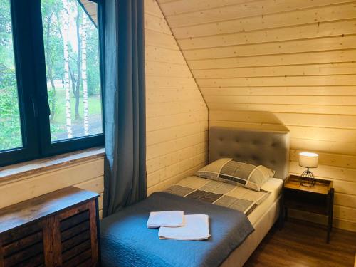1 dormitorio con 1 cama en una cabaña de madera en Modrynowe Domki en Wetlina