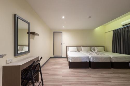 Postel nebo postele na pokoji v ubytování Siam Star Hotel