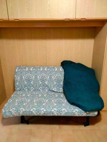 a couch with a green pillow sitting on a shelf at Appartamento incantevole con ampio balcone in Sella Nevea