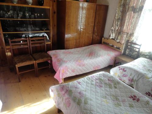Postel nebo postele na pokoji v ubytování Manoni Ratiani's Guesthouse