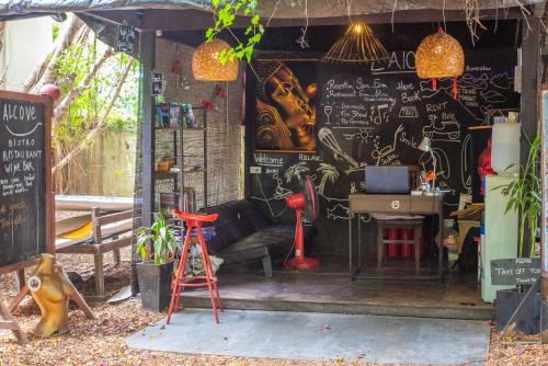 a room with a black wall with drawings on it at Alcove Bungalow in Hinkong