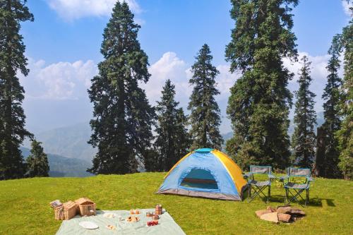 a tent and a table and chairs on a field at Taj Theog Resort & Spa Shimla in Shimla