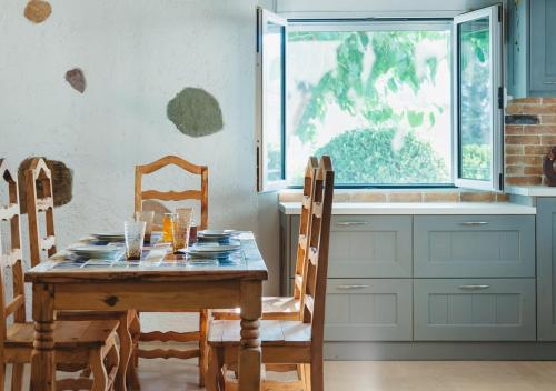 a kitchen with a table and chairs and a window at Villa “Alexis&Coco” traditional house in Tríkorfon