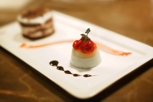 a dessert with a strawberry on a white plate at Lakeshore Banani in Dhaka