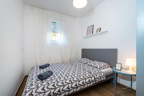 Postel nebo postele na pokoji v ubytování Apartment Sunset Rovanjska