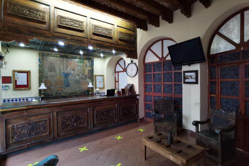 a large room with a bar in a building at CAPITAL O Meson De La Fragua in Guanajuato