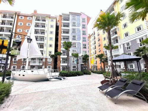 a sail boat on display in a courtyard with buildings at C24 Seven Seas Cote DAzur Luxury Private in Na Jomtien