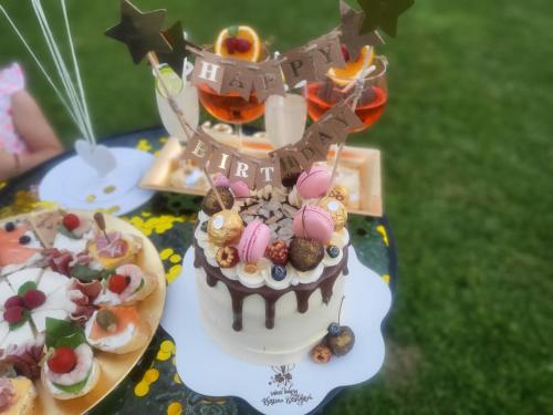 a birthday cake with a tower on top of it at Двете къщи в планината in Beli Osŭm