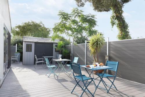 a patio with chairs and tables on a deck at Campanile Toulon - La Seyne sur Mer - Sanary in Six-Fours-les-Plages