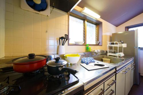 a kitchen with a stove with a pot on the stove at Bay view Sotetsu no yu in Beppu