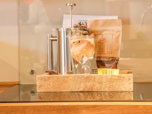 a glass display case with a drink on a table at Millgate House in Conwy