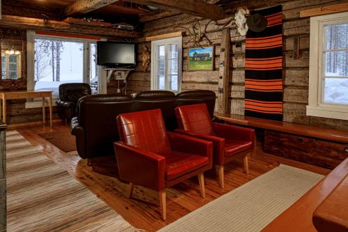 a living room with chairs and a flat screen tv at Kainuun Luontoretket in Hossa