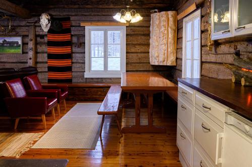 a kitchen with a table and chairs and a window at Kainuun Luontoretket in Hossa