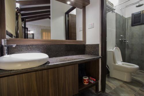 a bathroom with a sink and a toilet at Raniban Retreat in Pokhara