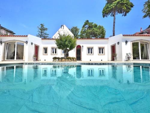 an empty swimming pool in front of a house at A Capela - A Essência de Sintra in Sintra