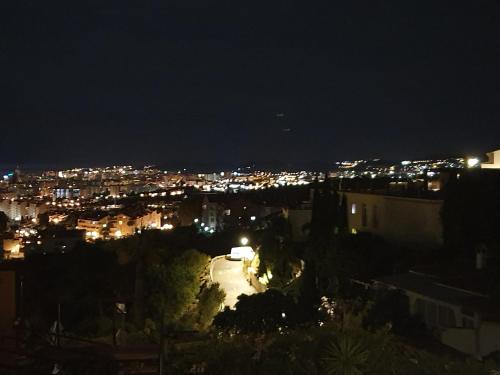 a view of a city at night at Cozy rooms in terraced house in Fuengirola