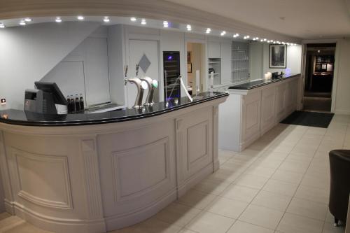 a large kitchen with a large counter with sinks at Kløver Hotel in Sauda